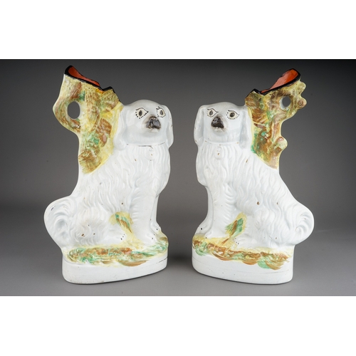 416 - A pair of Staffordshire large flatback spill vases modelled as large white Spaniels, approx 33cm at ... 