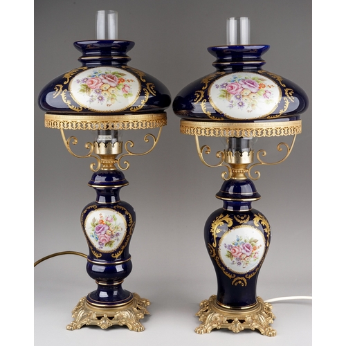 479 - A pair of Modern Limoges style cobalt blue gilt mounted lamps, baluster stems and shades painted wit... 