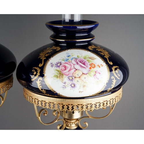 479 - A pair of Modern Limoges style cobalt blue gilt mounted lamps, baluster stems and shades painted wit... 