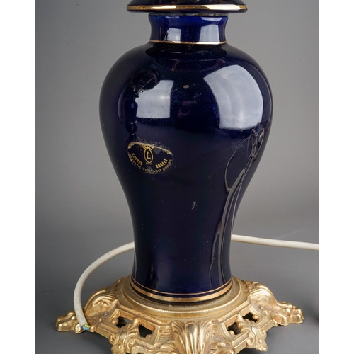 479 - A pair of Modern Limoges style cobalt blue gilt mounted lamps, baluster stems and shades painted wit... 