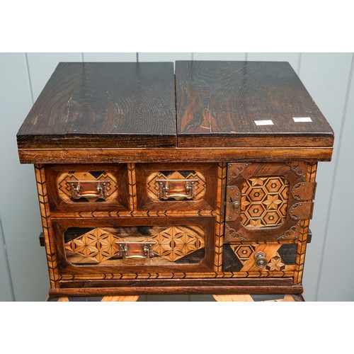 526 - A Japanese Meiji period parquetry cabinet on stand, the double hinged cover opens to reveal geometri... 