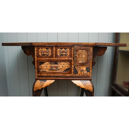 526 - A Japanese Meiji period parquetry cabinet on stand, the double hinged cover opens to reveal geometri... 