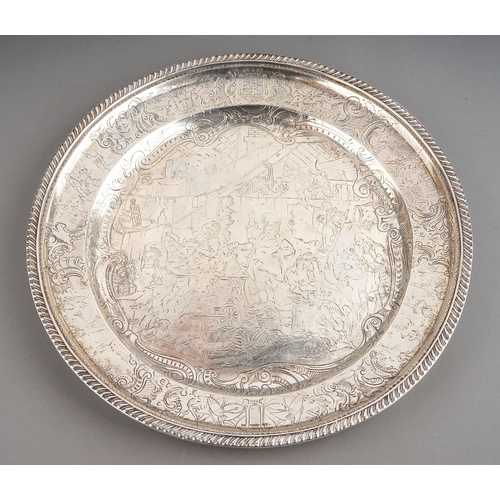 555 - A 19th Century Danish silver dinner plate with gadroon rim, the raised border with the Danish Royal ... 