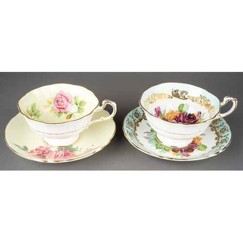 557 - Two paragon porcelain cups and saucers decorated with cabbage roses one on yellow and one on pale bl... 