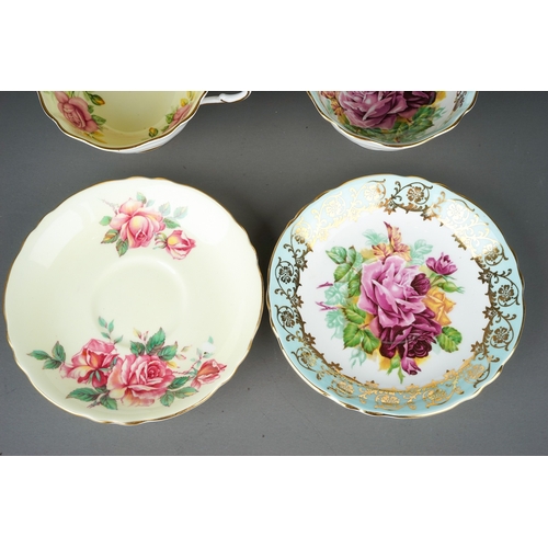 557 - Two paragon porcelain cups and saucers decorated with cabbage roses one on yellow and one on pale bl... 