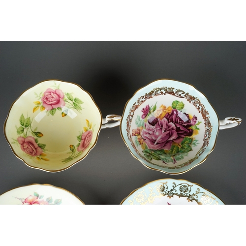 557 - Two paragon porcelain cups and saucers decorated with cabbage roses one on yellow and one on pale bl... 