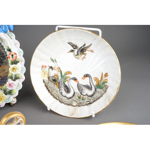 328A - A group of Continental porcelain to include: two early 20th Century Dresden Swan Service circular di... 