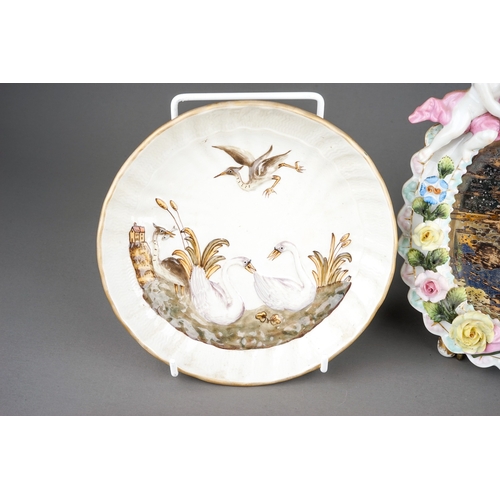 328A - A group of Continental porcelain to include: two early 20th Century Dresden Swan Service circular di... 