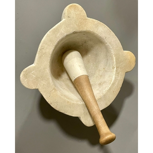 260A - A large marble mortar with associated stoneware pestle, 28 cm across