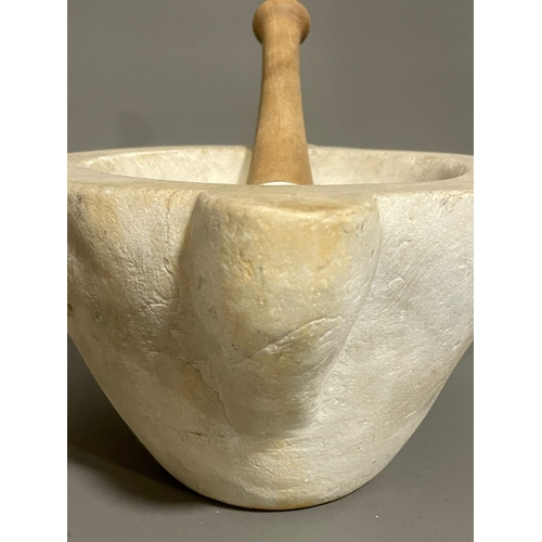 260A - A large marble mortar with associated stoneware pestle, 28 cm across