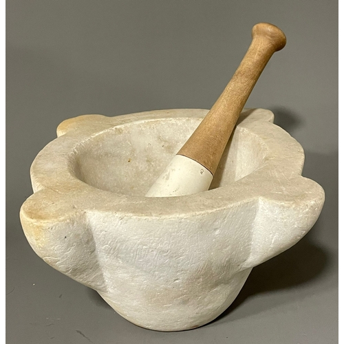 260A - A large marble mortar with associated stoneware pestle, 28 cm across