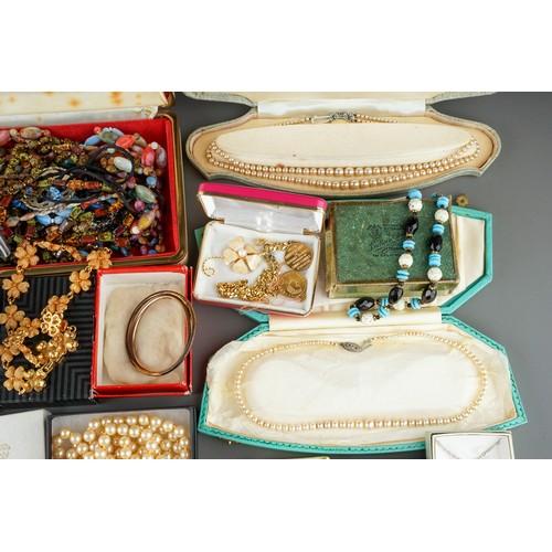 18 - A large collection of costume jewellery, including brooches, chains, beads, faux pearls, etc