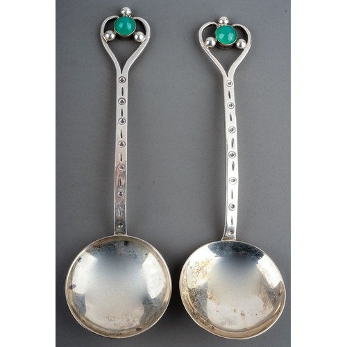 184A - A pair of Arts & Crafts silver spoons, stylised heart shaped openwork terminals with jade coloured c... 