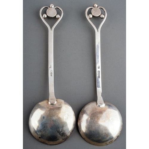 184A - A pair of Arts & Crafts silver spoons, stylised heart shaped openwork terminals with jade coloured c... 