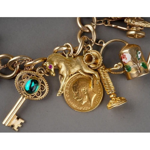 13 - A 9ct yellow gold charm bracelet, suspending a 1909 sovereign and two half sovereigns 1911/1914, and... 