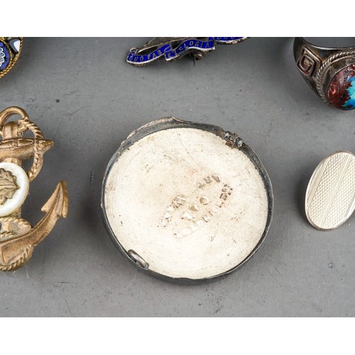 25 - A small collection of silver and costume jewellery, including a silver brooch in the form of a seate... 