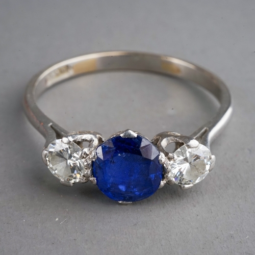 28 - A sapphire and diamond three-stone ring, set with a mixed-cut sapphire flanked by two round brillian... 