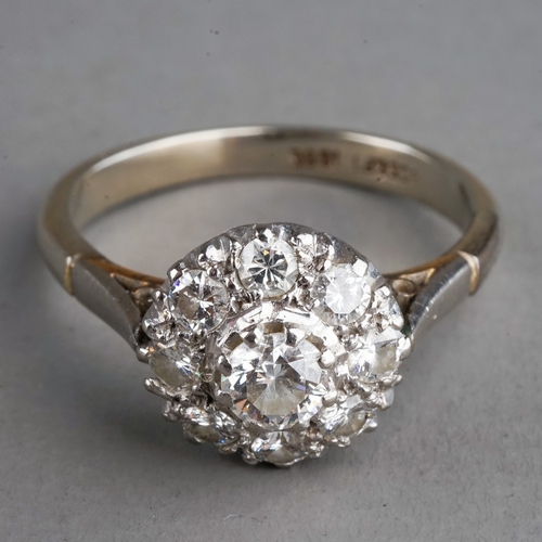 29 - An 18ct white gold and diamond cluster ring, the centre diamond approx 0.2ct within a border of smal... 