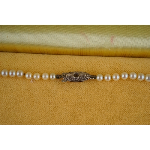 31 - A graduated string of cultured Mikimoto pearls, approx 3mm - 7mm, approx 43cm long, silver clasp wit... 