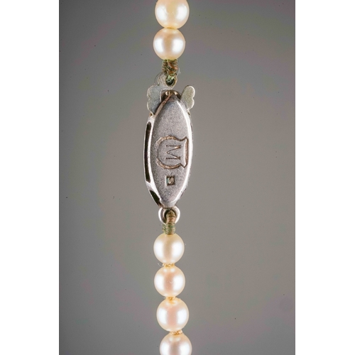 31 - A graduated string of cultured Mikimoto pearls, approx 3mm - 7mm, approx 43cm long, silver clasp wit... 