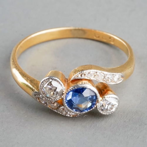 32 - An early 20th century sapphire and diamond ring, set with a round sapphire flanked by two diamonds, ... 