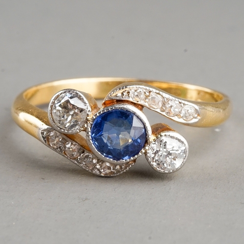 32 - An early 20th century sapphire and diamond ring, set with a round sapphire flanked by two diamonds, ... 