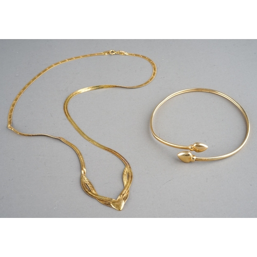 47 - A 9ct yellow gold necklace, approx 3.3g; and an unmarked yellow metal bangle, approx 3.2g (2)