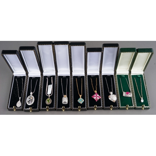 52 - A collection of silver gem-set pendant necklaces, including peridot and marcasite, ruby, CZ etc (9)