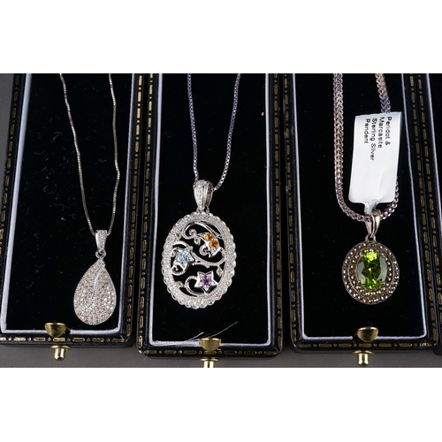 52 - A collection of silver gem-set pendant necklaces, including peridot and marcasite, ruby, CZ etc (9)