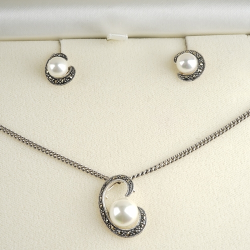 94 - Silver and pearl marcasite necklace and earring set in a box, marked 925