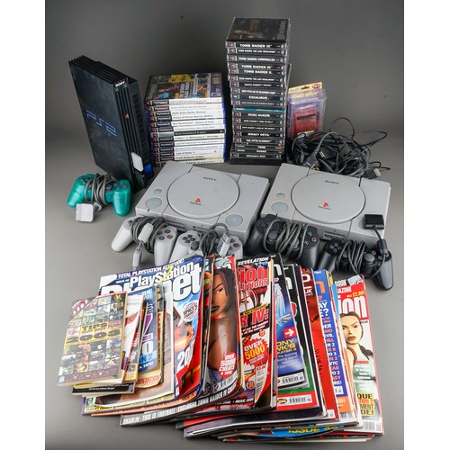 106 - Two Sony PlayStation 1s and a Sony Playstation 2 game consoles with five controllers together with a... 