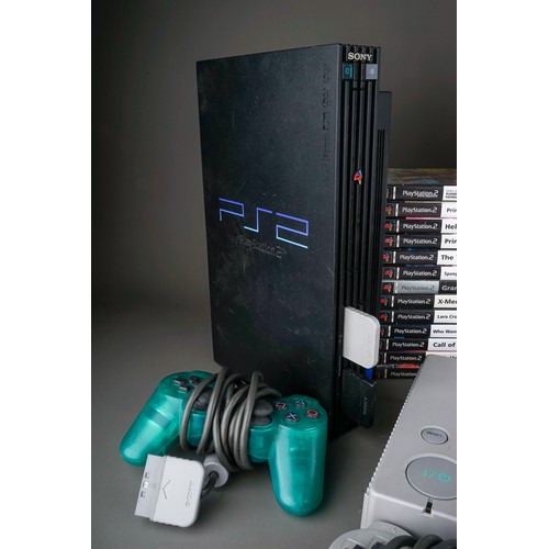 106 - Two Sony PlayStation 1s and a Sony Playstation 2 game consoles with five controllers together with a... 