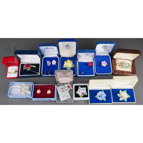 107 - 13 boxed porcelain brooches , earrings and pins to include Aynsley, Coalport, Hammersley ( 1 bag)