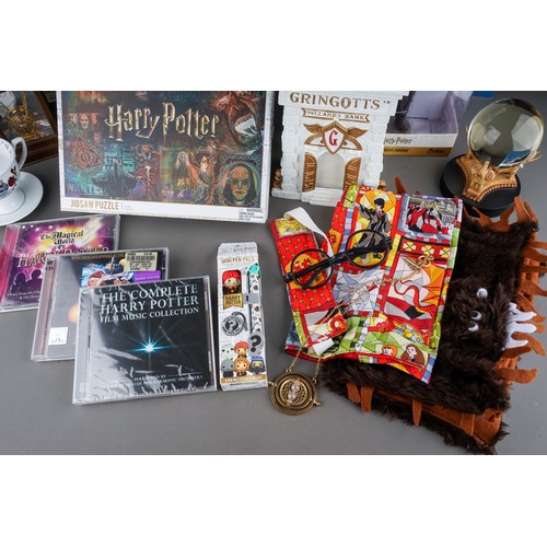 121 - Harry Potter memorabilia to include: The History of Magic snow globe; boxed Rubeus Hagrid figure; Ha... 