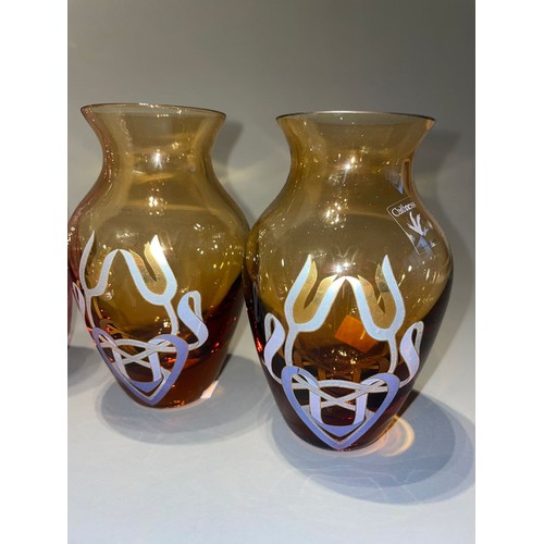 136 - Caithness: a pair of amber Tulip pattern vases together with two fluted vases, a bowl and a Spinning... 