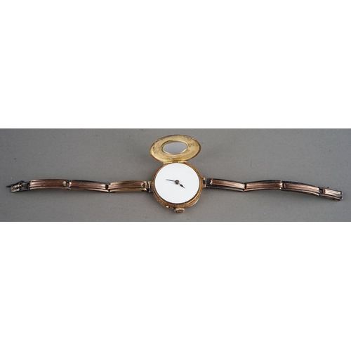 149 - A ladies 9ct gold wristwatch, circular white enamel dial, Roman numerals to outer gold bezel, on a 9... 