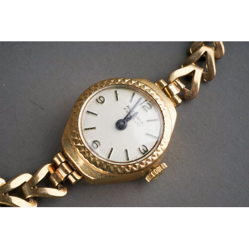 150 - A ladies 9ct yellow gold case wristwatch, with a rolled gold bracelet strap