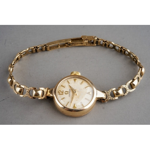 152 - A ladies 9ct yellow gold Omega wristwatch, circular dial, case approx 18mm, integral 9ct gold strap,... 