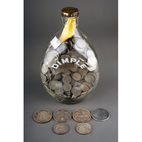 185 - A Dimple whisky bottle containing a large quantity of six pence pieces, approximately 1150 according... 