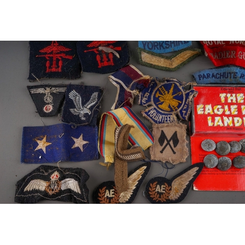 203 - Tin containing a quantity of WW2 era cloth patches including NZ Airforce., Royal Winnipeg Rifles, Gr... 