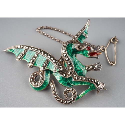 226 - A silver and enamel brooch, in the form of a dragon, green enamelled body, marcasite set wings and t... 