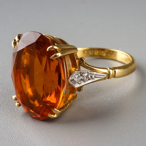 230 - An 18ct yellow gold citrine and diamond dress ring, set with an oval cut citrine in claw settings, d... 