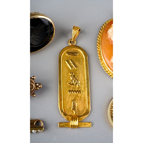 241 - An Egyptian gold oval pendant, cast with hieroglyphics, approx 3.5g; a yellow gold and seed pearl ba... 