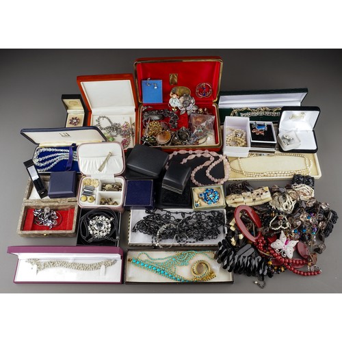 245 - A large collection of costume jewellery, including brooches, earrings, necklaces, bracelets, badges,... 