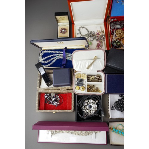 245 - A large collection of costume jewellery, including brooches, earrings, necklaces, bracelets, badges,... 