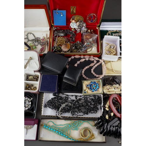 245 - A large collection of costume jewellery, including brooches, earrings, necklaces, bracelets, badges,... 