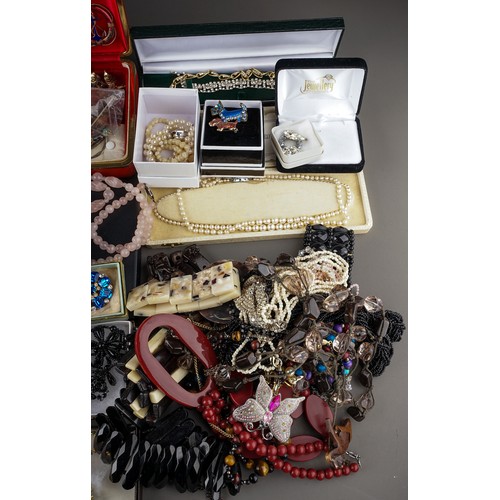 245 - A large collection of costume jewellery, including brooches, earrings, necklaces, bracelets, badges,... 