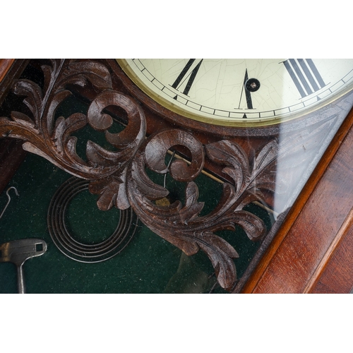 253 - A late 19th century mahogany cased drop case wall clock, the arched top with central cresting, paint... 