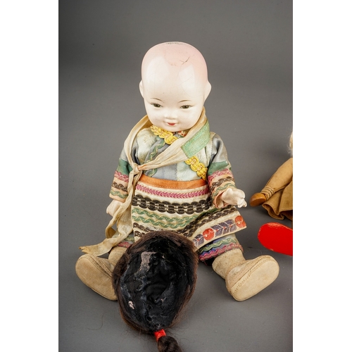 265 - Two mid 20th century composition Chinese costume dolls of a boy and a girl, s.d., heights 21cm appro... 