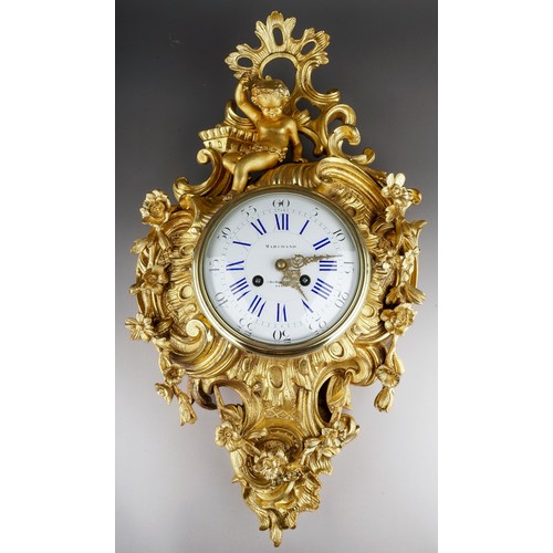 A 19th century Marchand of Paris ormolu cartel clock, the Rococo style case cast with a putti sitting in front of scrolls and swags of flowers, the circular enamel dial with Roman and Arabic numerals, signed 'Marchand 17, Rue Boissy d'Anglas, Paris', eight day movement, bell strike, movement stamped M.C 262 86, height 60cm x width 35cm, with pendulum, key supplied.